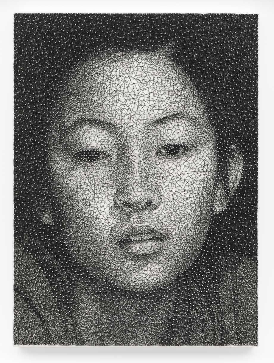 A portrait of a Japanese woman's face, composed entirely of brads and a single, unbroken black thread on wood.