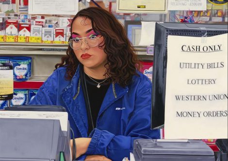A portrait of a woman seated behind a customer service desk.