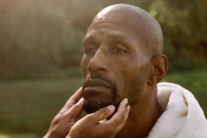 Man with someone's hands under his chin