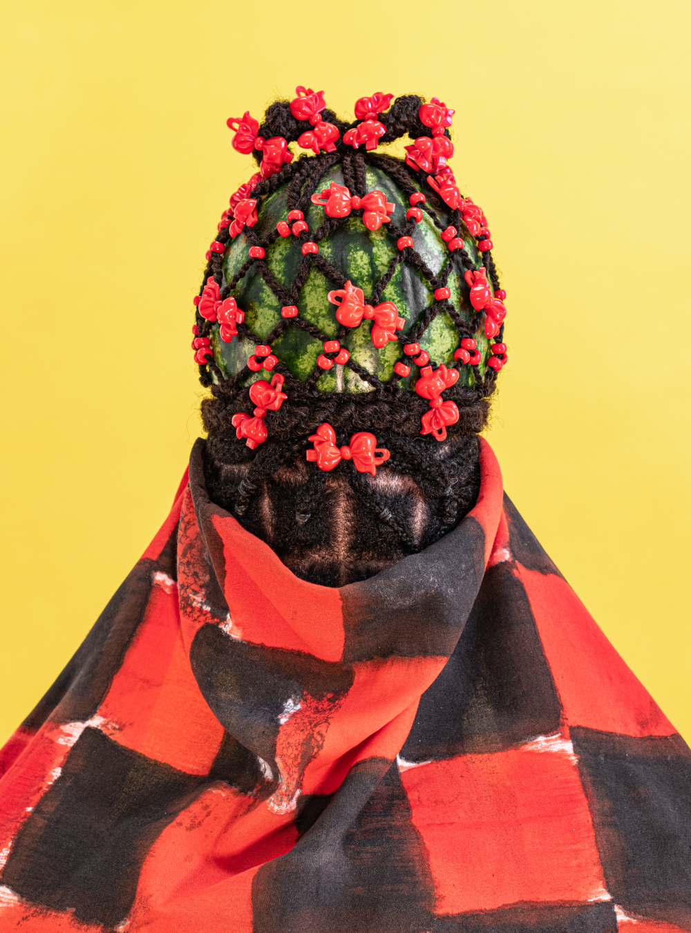 A watermelon with hair and bows